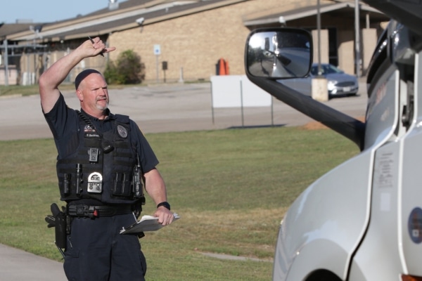 Officer Darren Burkhart raising his right arm