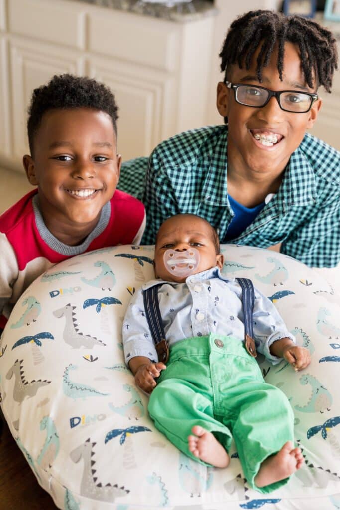 Caden, 10, and Caius, 4, Thorpe with their newborn brother.