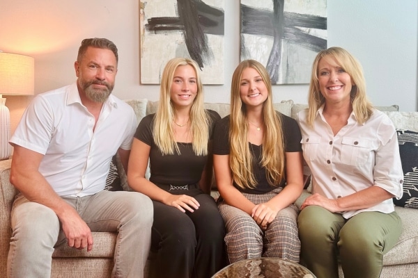 Rachel Richie photographed on a couch with her father, Terry, sister, Olivia, and mother, Stacie.