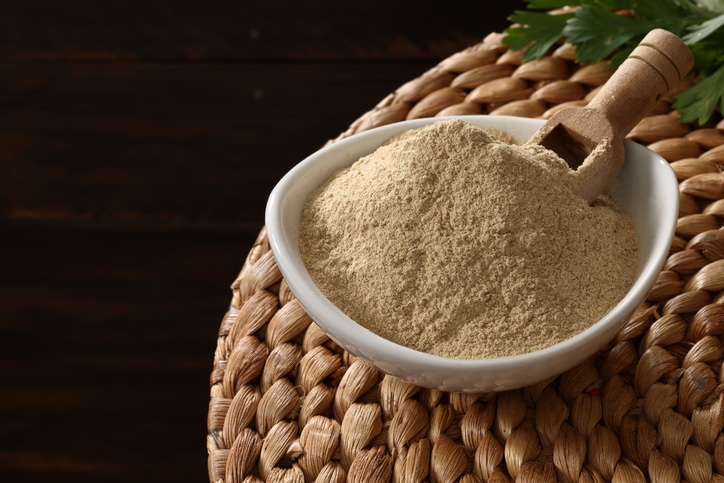 A white bowl with powdered ashwagandha