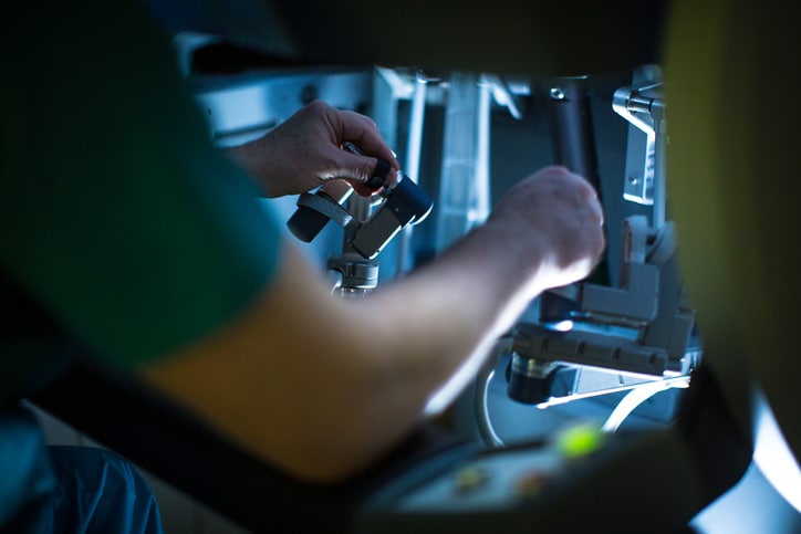 A trained medical provider controlling an assistive da Vinci robot