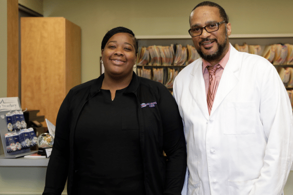 Joy Washington poses with Michael Young at their workplace.