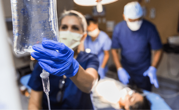 A medical provider holding an IV fluids bag, used to explain sepsis risk