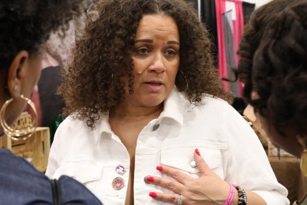 Nicole Kirkendoff in deep conversation with two other women in the foreground