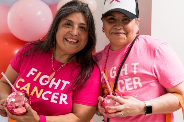Innocente photographed with her sister Monica wearing T-shirts that say "Fight Cancer"