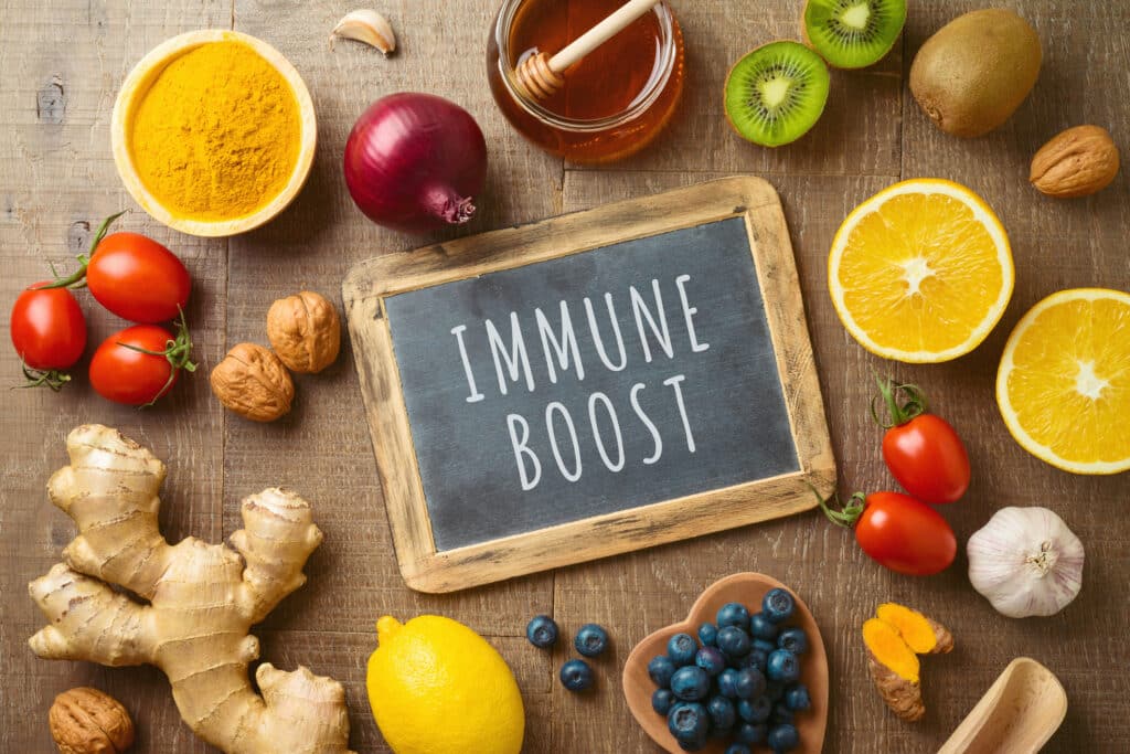 Superfoods arranged around a chalk sign with the words "immune boost"