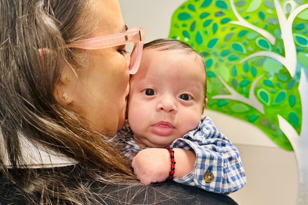 Joanna Navarette photographed kissing the side of her baby's Jacob's head while Jacob looks at the camera