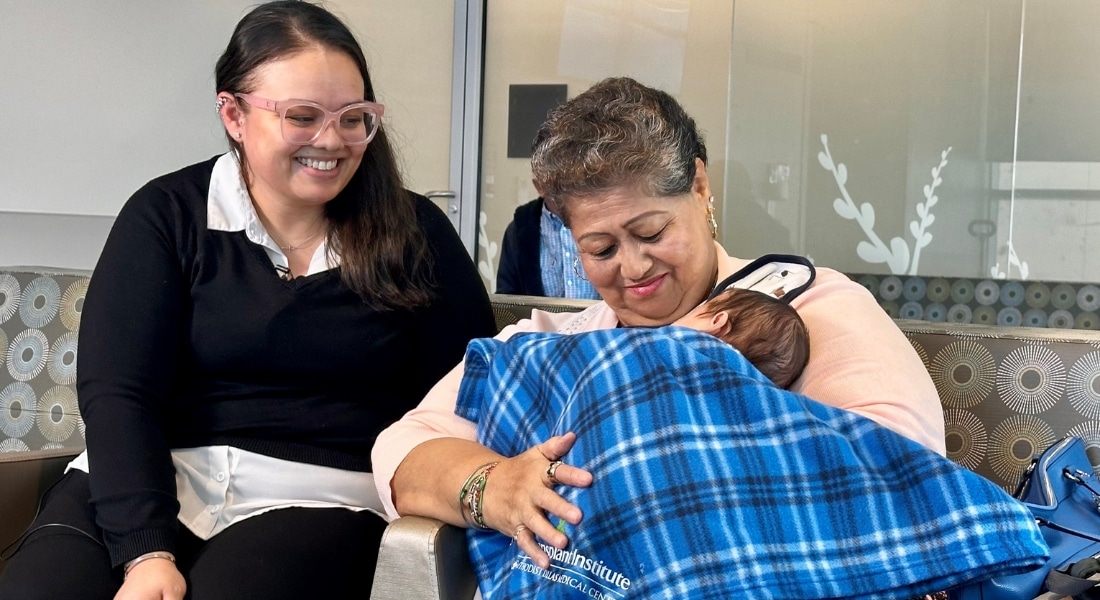 Joanna Navarette standing behind her mother, Maria, who holds Joanna's newborn, Jacob Jr., at Methodist Dallas Medical Center after Joanna donated a kidney to Maria