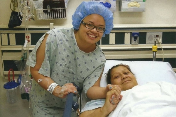 Joanna Navarette and her mother, Maria, photograhed in a medical room while Joanna wear scrubs