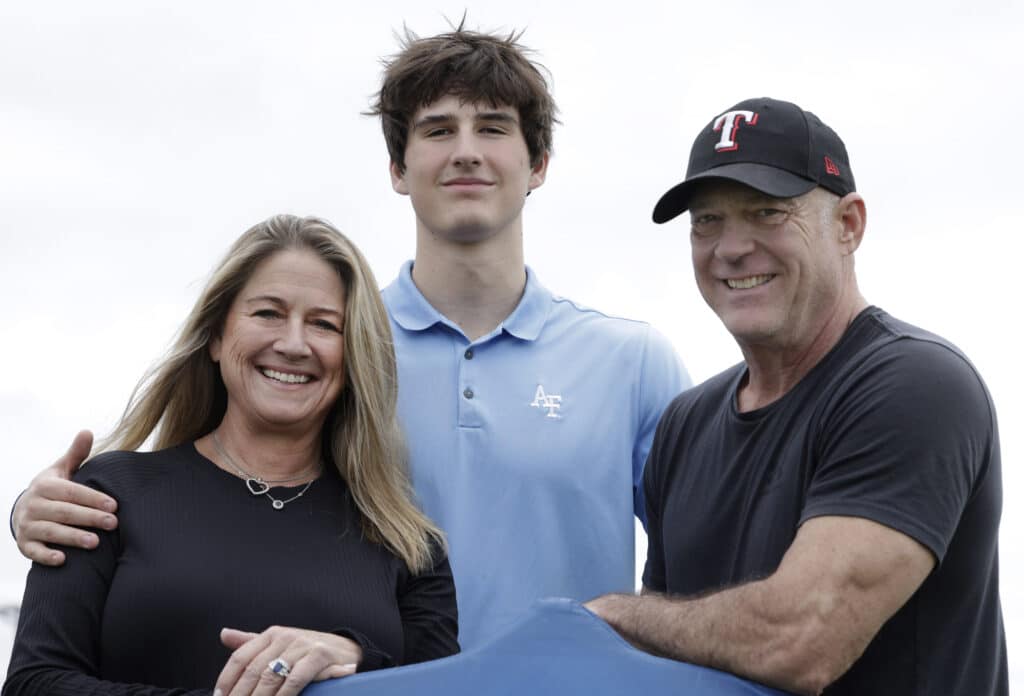Liberty Christian wide receiver Henri DeRoche photographed with his mom Kelly and an older man