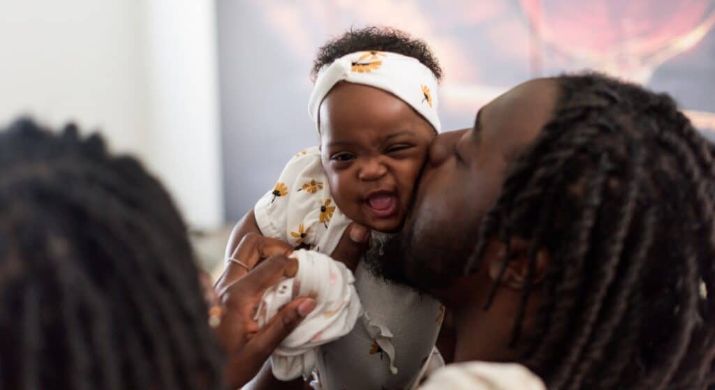 Sharif Thompson gives his daughter Rhea a kiss.