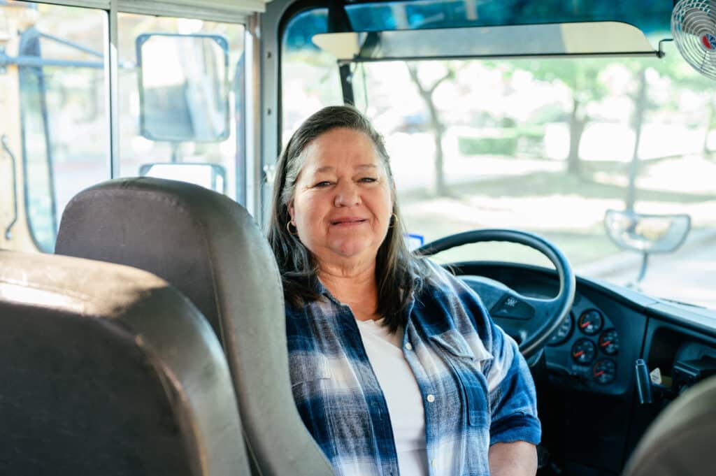 Delonda Faltesek sits at the wheel of a school bus at Oak Park School.