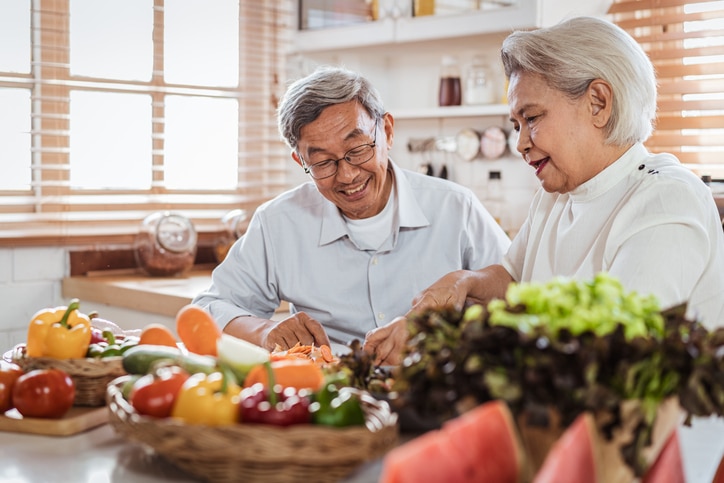 Senior couple cooking together in the kitchen.