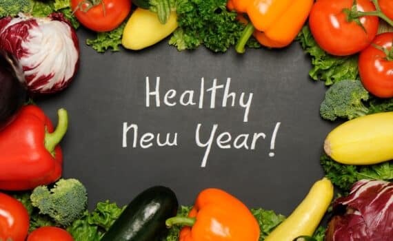 Healthy new year resolution concept with blackboard and vegetables.