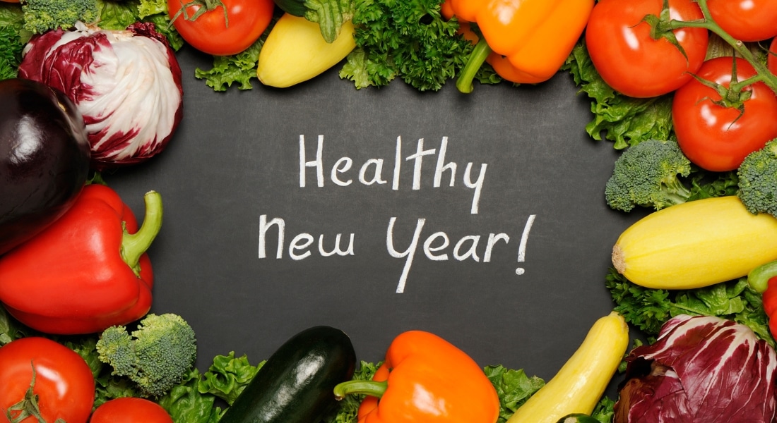 Healthy new year resolution concept with blackboard and vegetables.