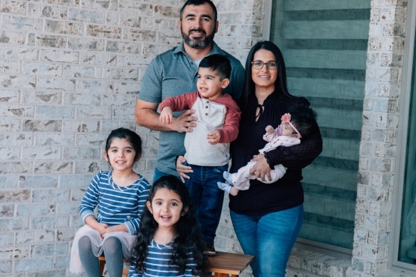 Kiran Lalani and her family outside their home in Ennis