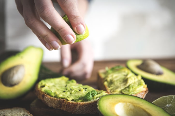 Close up of a tomato and avocado sandwich