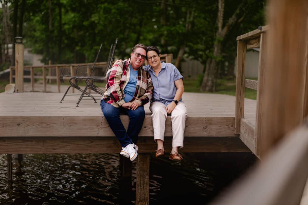 Transplant patient Joy Salvatore and her partner Sharon Kerr sit on a dock near their home outside Waco.