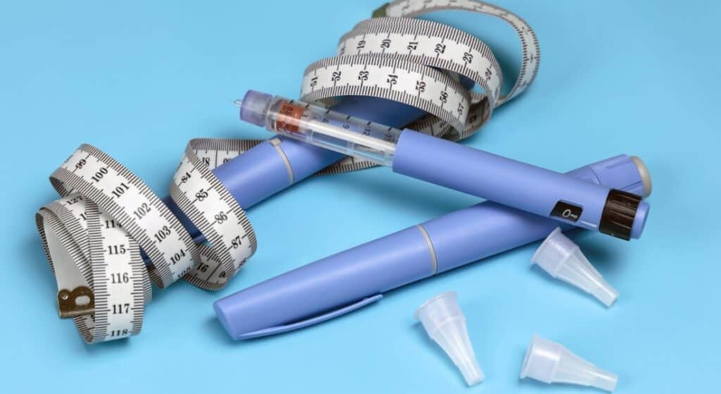 Image of injectable weight loss drugs with a measuring tape