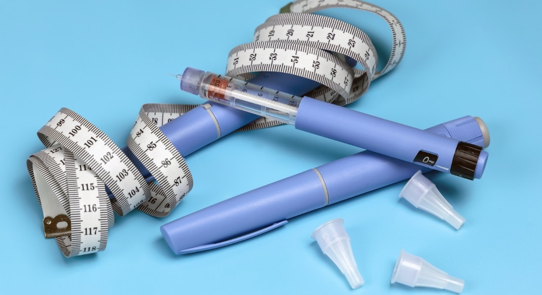 Image of injectable weight loss drugs with a measuring tape
