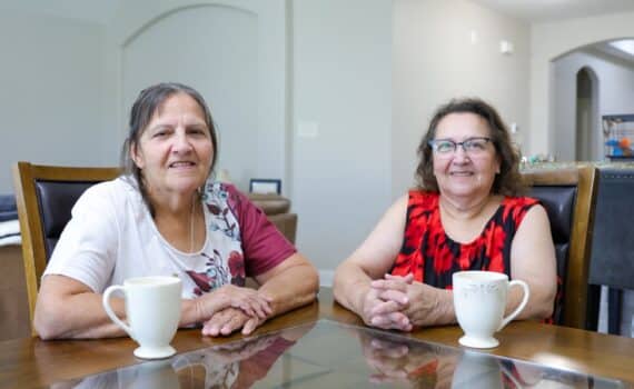 Heart patients Mary Stierhoff and Carmen Alfaro share cups of coffee at their dining room table.