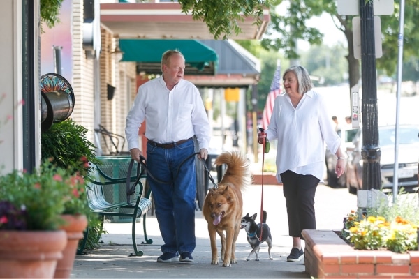 Leon and Susan Mullins walk their dogs through downtown Mansfield.