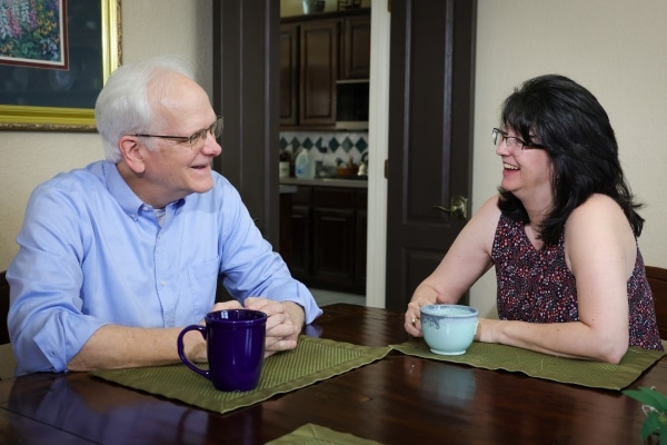 Rod Milton enjoys a cup of coffee with his wife, Leah, at their dining room table.