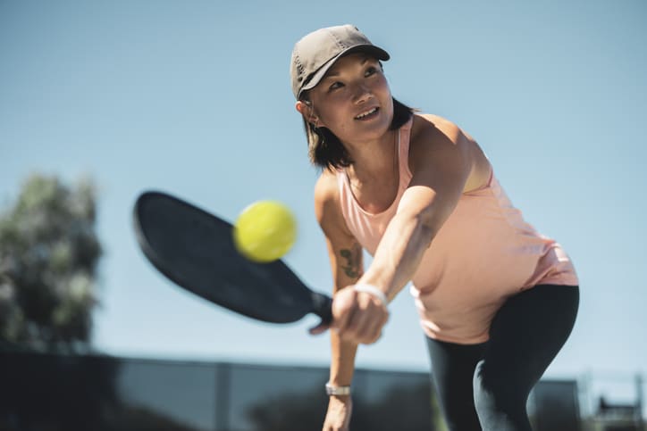 Asian woman playing pickleball