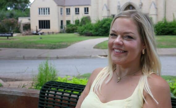 Transplant recipient sits on a bench across from a church in Wichita Falls.