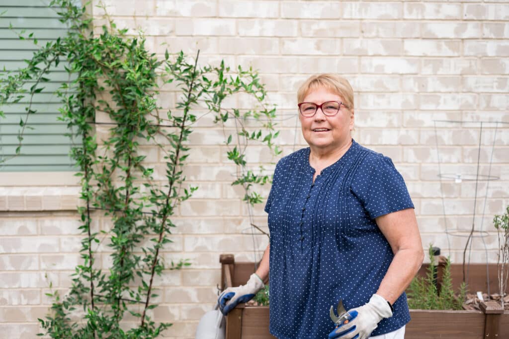 Jackie Lipscomb stands beside her raised garden beds at her home in Midlothian.