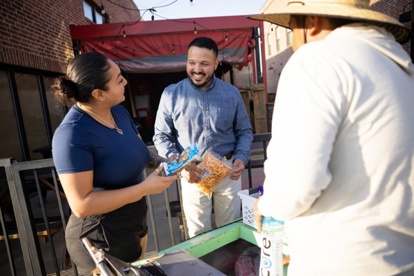 Heart attack survivor Eddie Conde buys from a street cart vendor outside his Midlothian restaurant