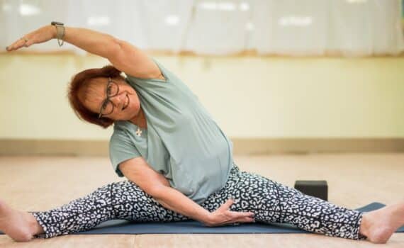 Breast cancer survivor Lanelle Maddox practices yoga at her gym.