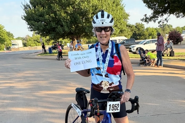 Lung cancer survivor Nan Ehrsam takes a break during a bicycle race.
