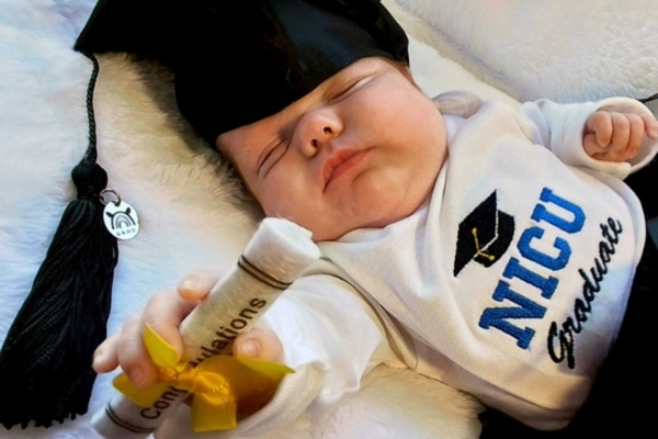 Preemie Poppy DeWald donned a graduation cap and onesie upon her release from the NICU.
