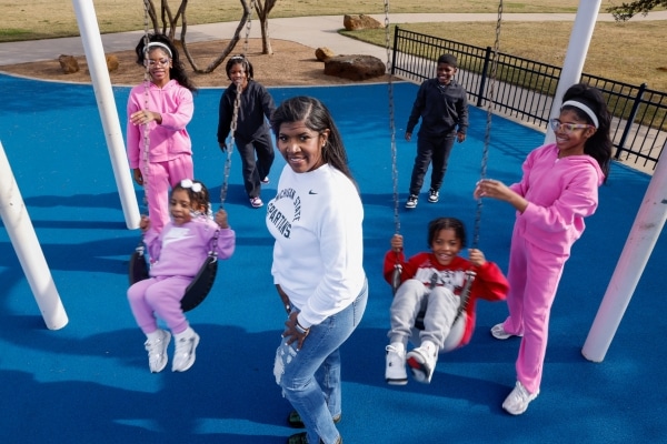 Jennifer Pulliam's six children play on a playground at a Mansfield park.