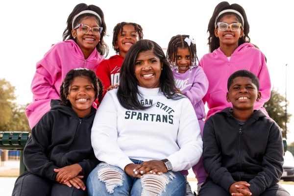 Jennifer Pulliam and her six children pose at a park near their Mansfield home.
