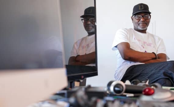 Cancer survivor Greg Williams sits at his work station at home.
