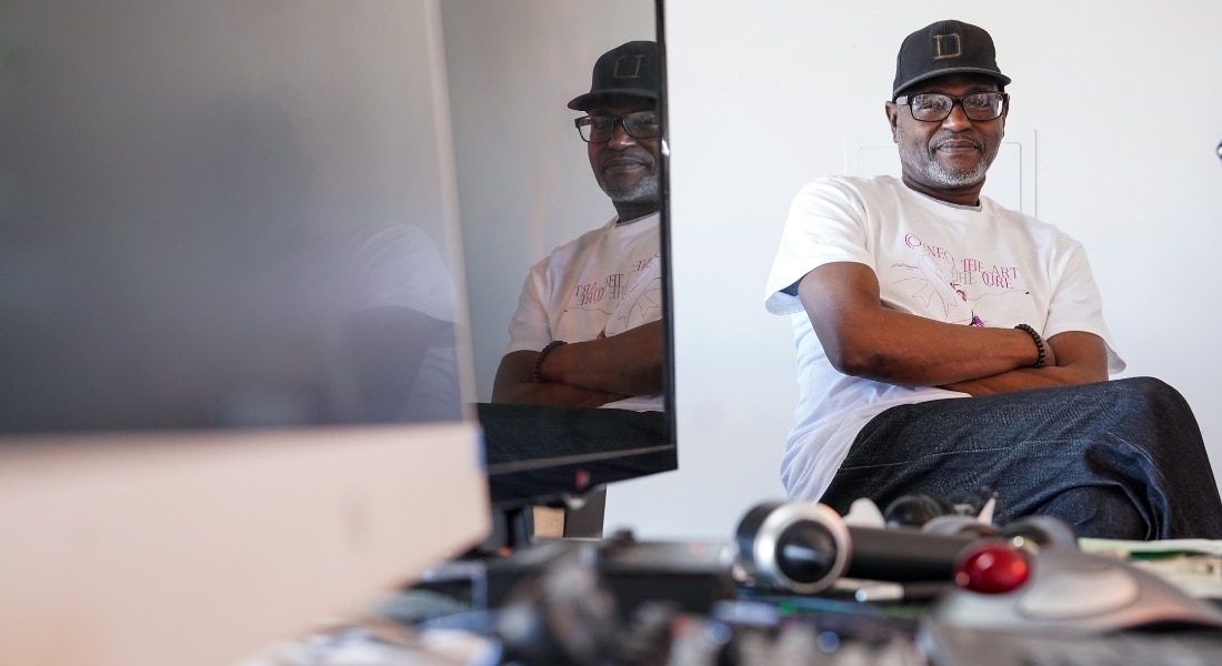 Cancer survivor Greg Williams sits at his work station at home.