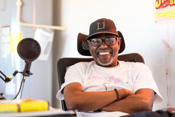 Cancer survivor Greg Williams sits at his work station at home.