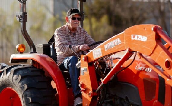 Lung cancer survivor drives a tractor on his farm in Waxahachie.