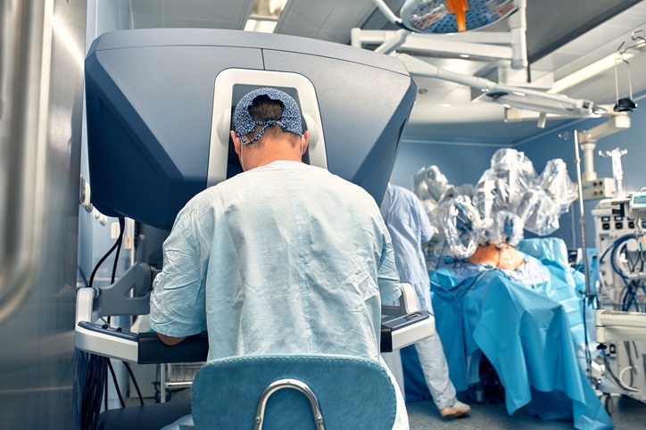 Carrying out an operation using a robot, a robot surgeon with manipulators, a modern operating room, surgeons people perform an operation using a surgeon's robot through the control panel