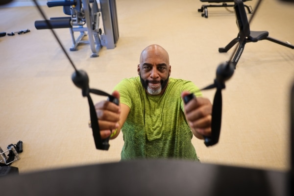 Spinal surgery patient Robert Flagg works out in a gym.