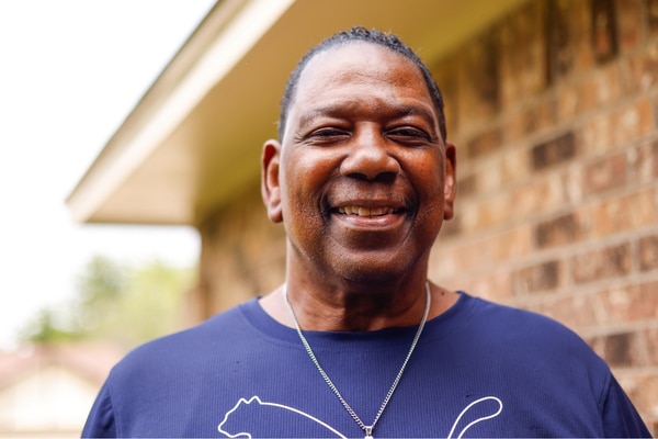 Larry Revels stands outside his home in Cedar Hill.