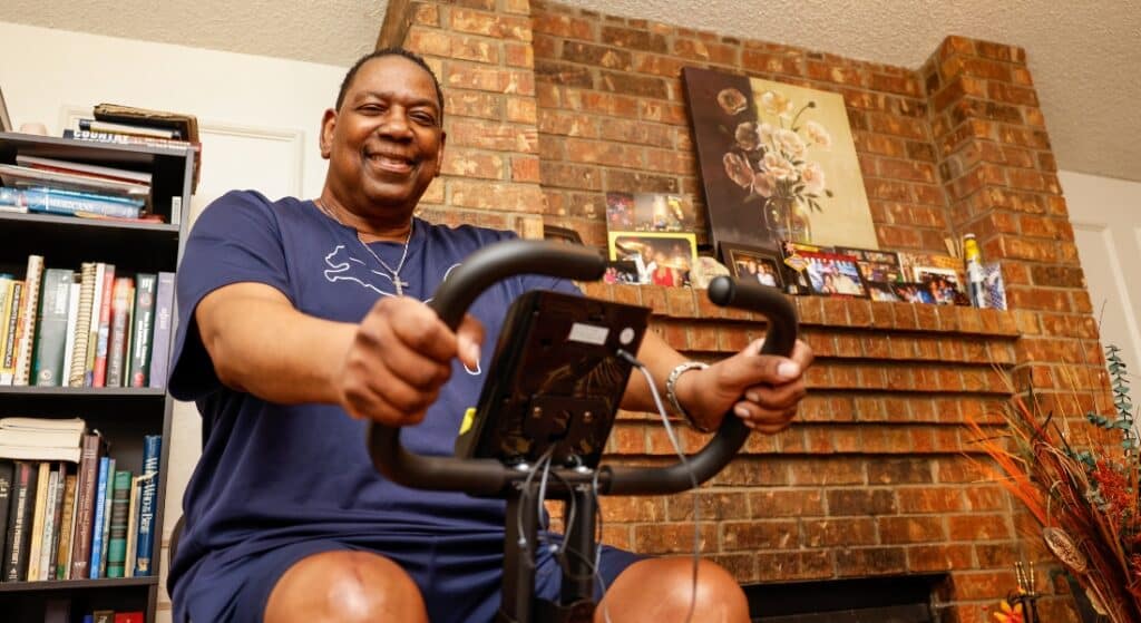 Larry Revels rides his stationary bike at his home in Cedar Hill.