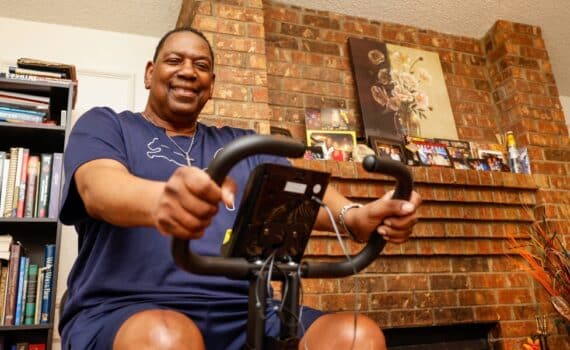 Larry Revels rides his stationary bike at his home in Cedar Hill.