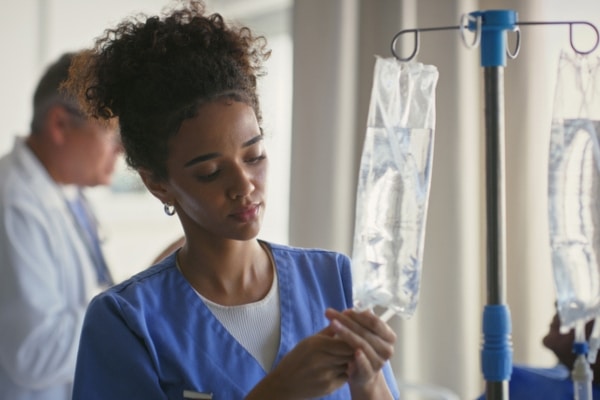 Healthcare, drip and nurse in hospital, fluid and infusion of IV medication and medical professional