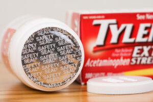 A bottle of acetaminophen rests on a table.