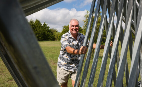 Nick Petrichenko leans against one of his welding sculptures outside his Ovilla home.