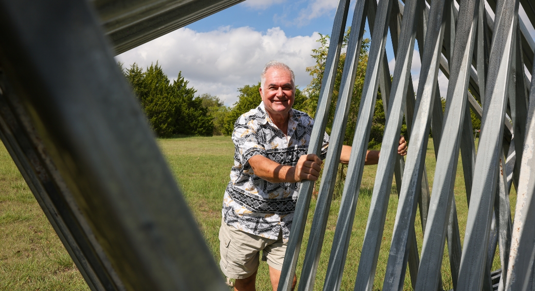 Nick Petrichenko leans against one of his welding sculptures outside his Ovilla home.